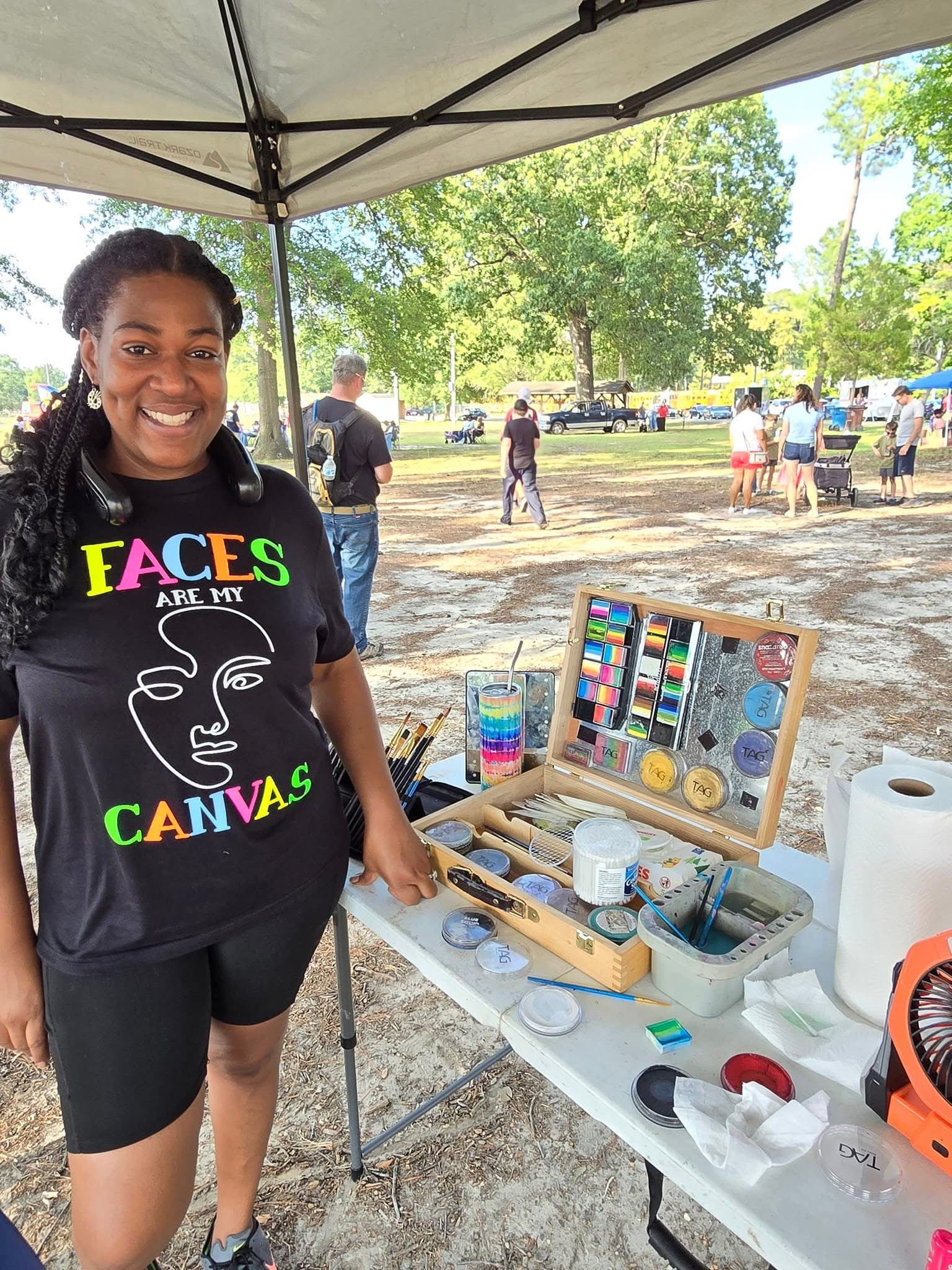 Strokes Of Faith artist at community event with professional face painting setup